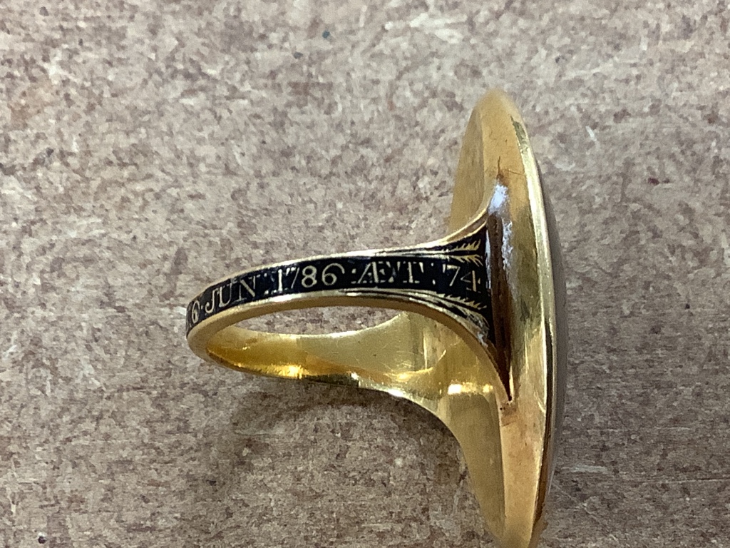 A George III yellow metal and three colour enamel navette shaped mourning ring, with Ducal coronet above 'N' on a pedestal with urn above, the shank with black enamel inscription which reads 'HU. DUX NORTHbr. OB 6 Jun. 1